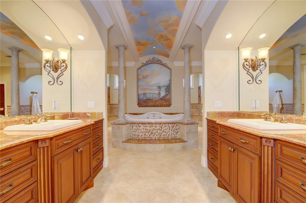 1227 Osowaw Boulevard Spring Hill, FL 34607 - Photo 47 of 96 a spacious bathroom with a granite countertop double vanity sink a mirror a bathtub and shower