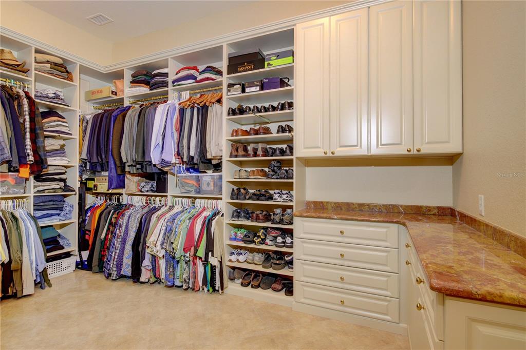 1227 Osowaw Boulevard Spring Hill, FL 34607 - Photo 50 of 96 a view of walk in closet with clothes and shoes