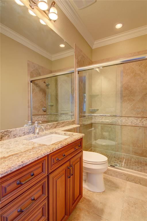 1227 Osowaw Boulevard Spring Hill, FL 34607 - Photo 58 of 96 a bathroom with a granite countertop sink a toilet and shower