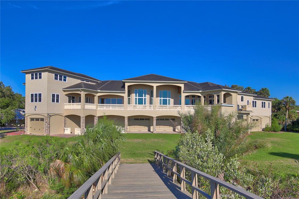 1227 Osowaw Boulevard Spring Hill, FL 34607 - Photo 70 of 96 a front view of a house with a yard