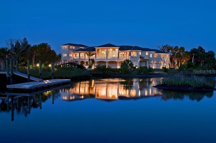 1227 Osowaw Boulevard Spring Hill, FL 34607 - Photo 87 of 96 a view of a lake with a house in the background