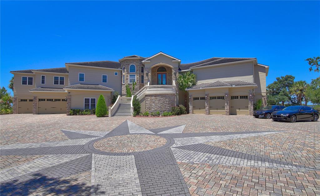 1227 Osowaw Boulevard Spring Hill, FL 34607 - Photo 9 of 96 a front view of a house with a yard and garage