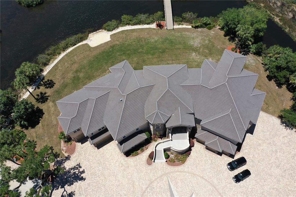 1227 Osowaw Boulevard Spring Hill, FL 34607 - Photo 93 of 96 an aerial view of a house with a yard and large trees