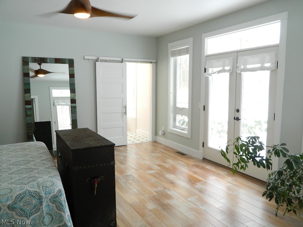 12464 Hotchkiss Road Burton, OH 44021 - Photo 11 of 35 An Abundance of Light Through French Doors, Patio Access; Barn Door to the Newly Remodeled Master Bathroom