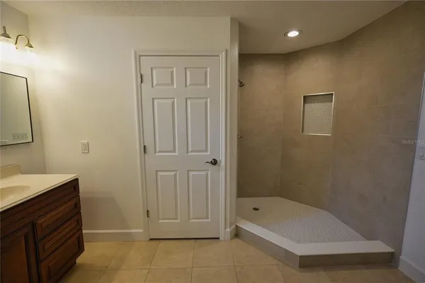 a bathroom with a tub a sink and a shower