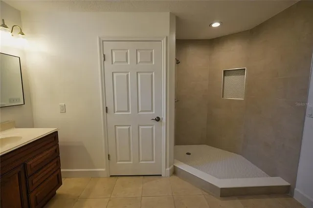 a bathroom with a tub a sink and a shower