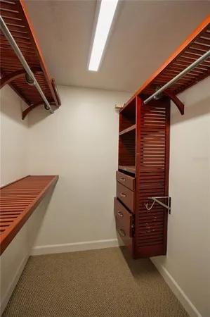 a view of walk in closet with clothes