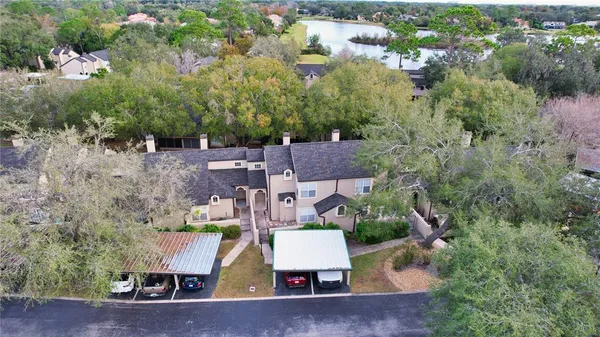 an aerial view of a house with a yard basket ball court and outdoor seating