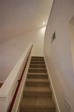 a view of living room with furniture and a floor to ceiling window