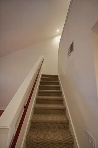 a view of living room with furniture and a floor to ceiling window