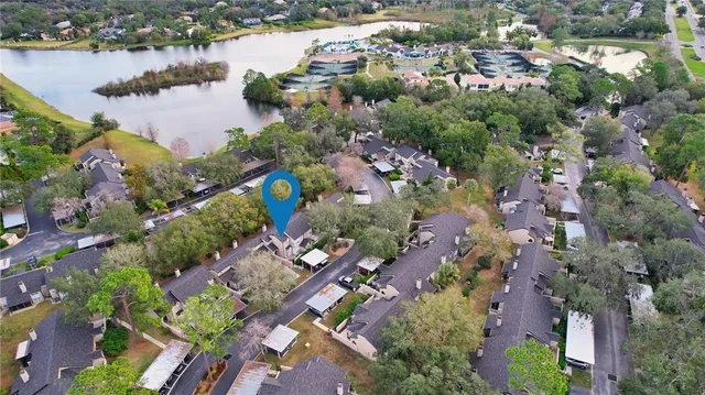 an aerial view of lake and houses with outdoor space