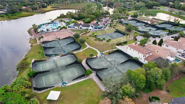 an aerial view of a house with yard swimming pool and outdoor seating