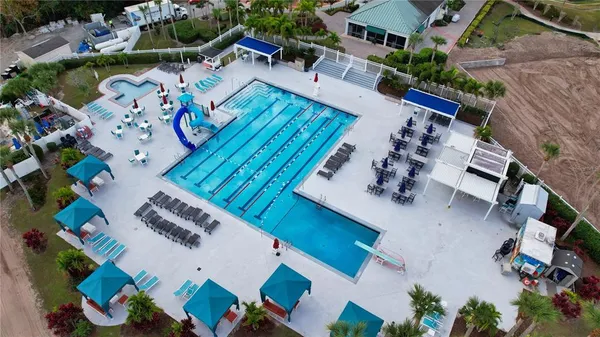 an aerial view of a house a yard swimming pool and outdoor seating