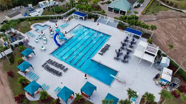 an aerial view of a house a yard swimming pool and outdoor seating