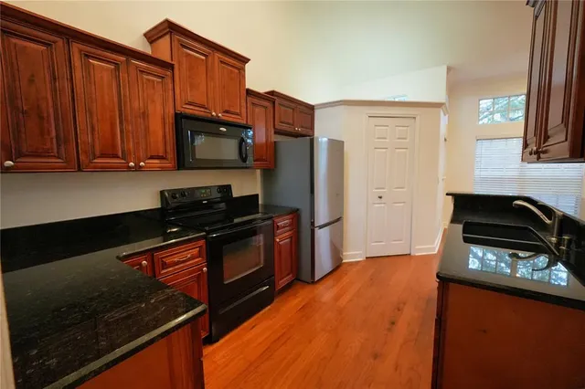 a kitchen with stainless steel appliances a stove a sink and a microwave
