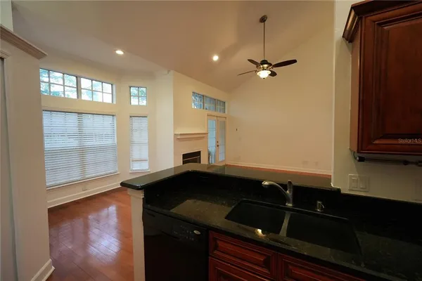 a view of a sink and dishwasher with wooden floor
