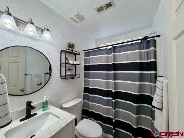 544 20th Street Delta, CO 81416 - Photo 26 of 44 a bathroom with a sink a toilet and a mirror