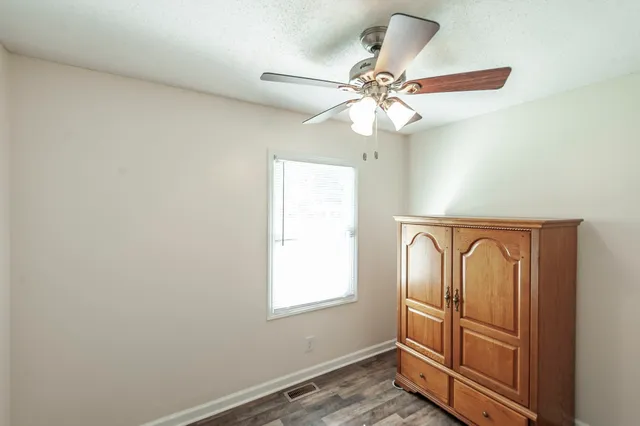 a view of a livingroom with a chandelier fan