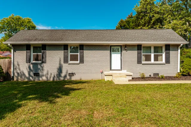 a view of a house with swimming pool and a yard
