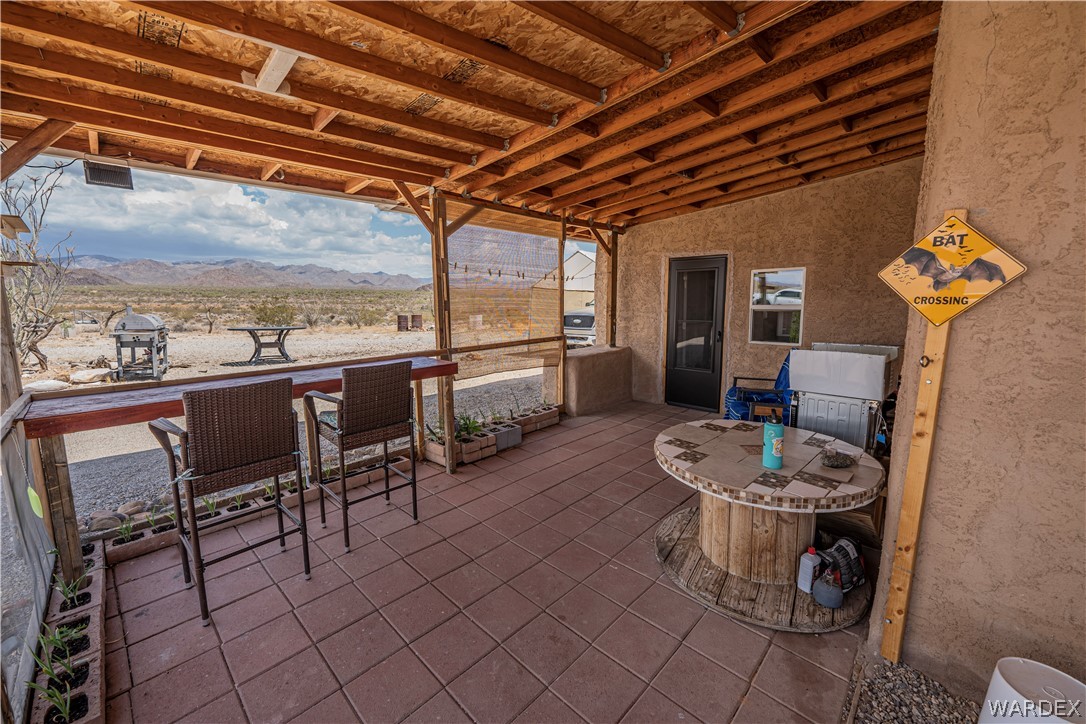 2620 Voss Road Yucca, AZ 86438 - Photo 29 of 40 a dining room with furniture and a floor to ceiling window