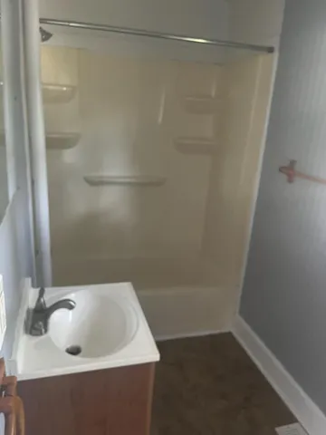 a bathroom with a sink and shower
