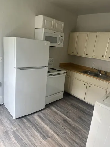 a utility room with cabinets washer and dryer
