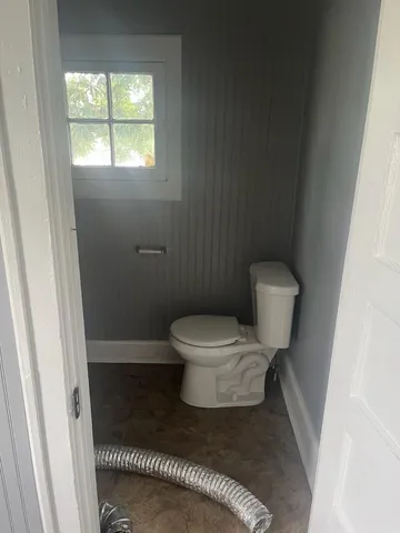 a white toilet sitting next to a small sink