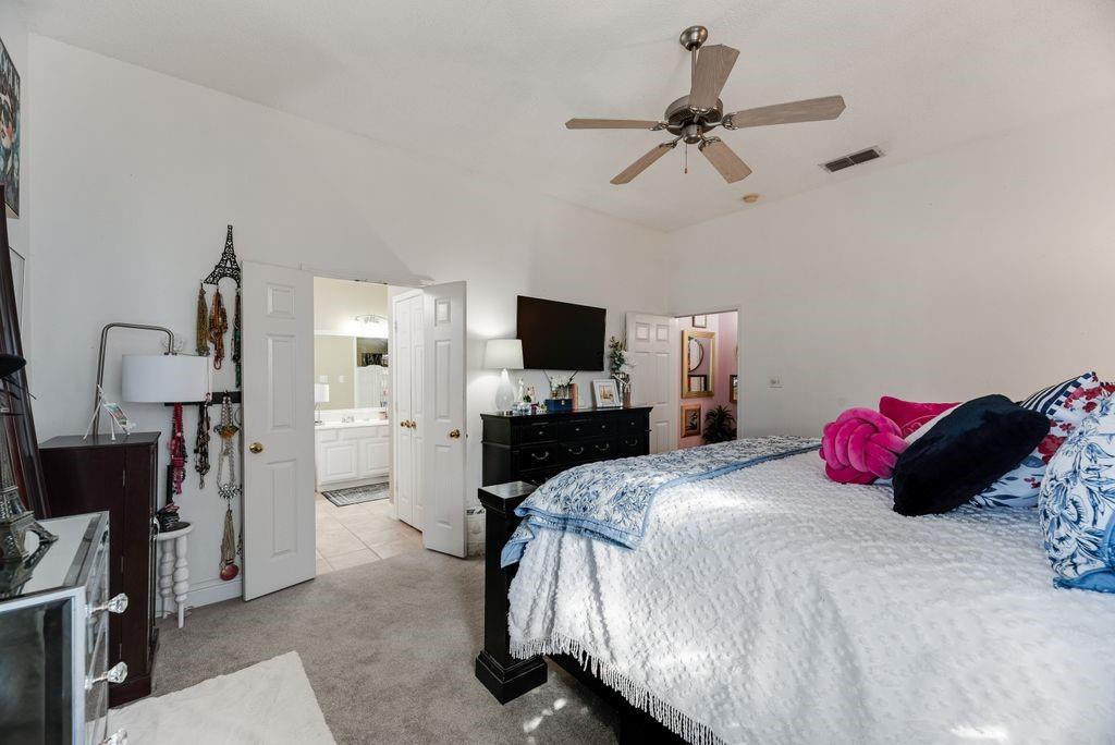 3205 Cape Cod Court Arlington, TX 76017 - Photo 17 of 30 a bedroom with a bed and a flat tv screen