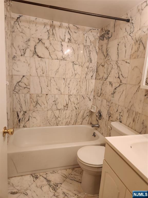 840 River Road, Unit 302 Edgewater, NJ 07020 - Photo 6 of 6 a bathroom with a toilet and a bathtub