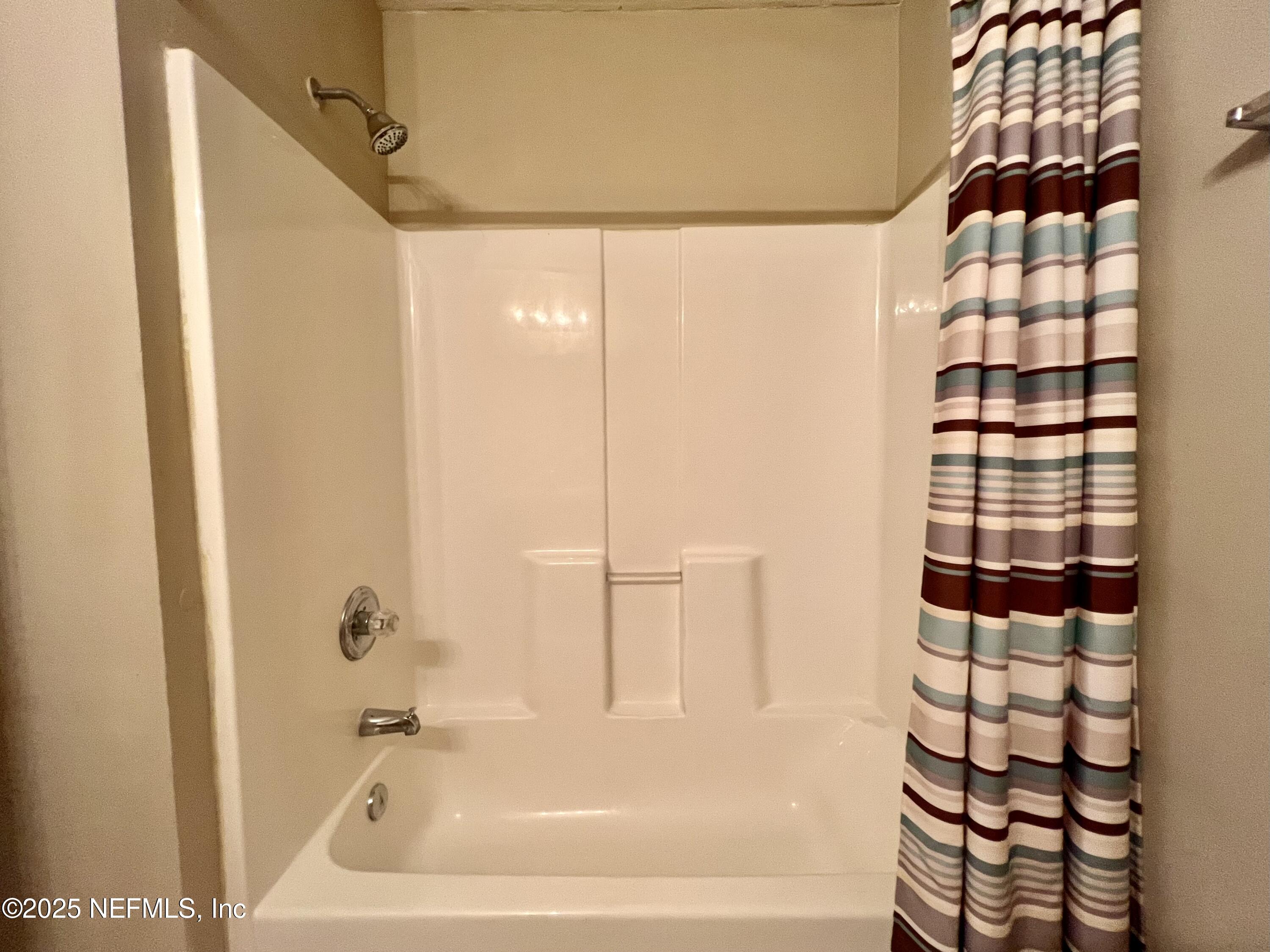 7920 Merrill Road, Unit 709 Jacksonville, FL 32277 - Photo 16 of 35 a bathroom with a bathtub and shower