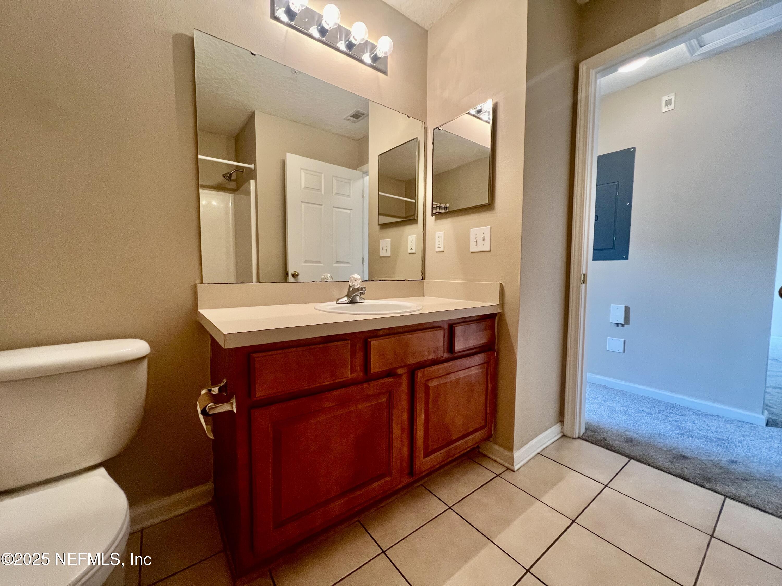 7920 Merrill Road, Unit 709 Jacksonville, FL 32277 - Photo 17 of 35 a bathroom with a sink and a mirror