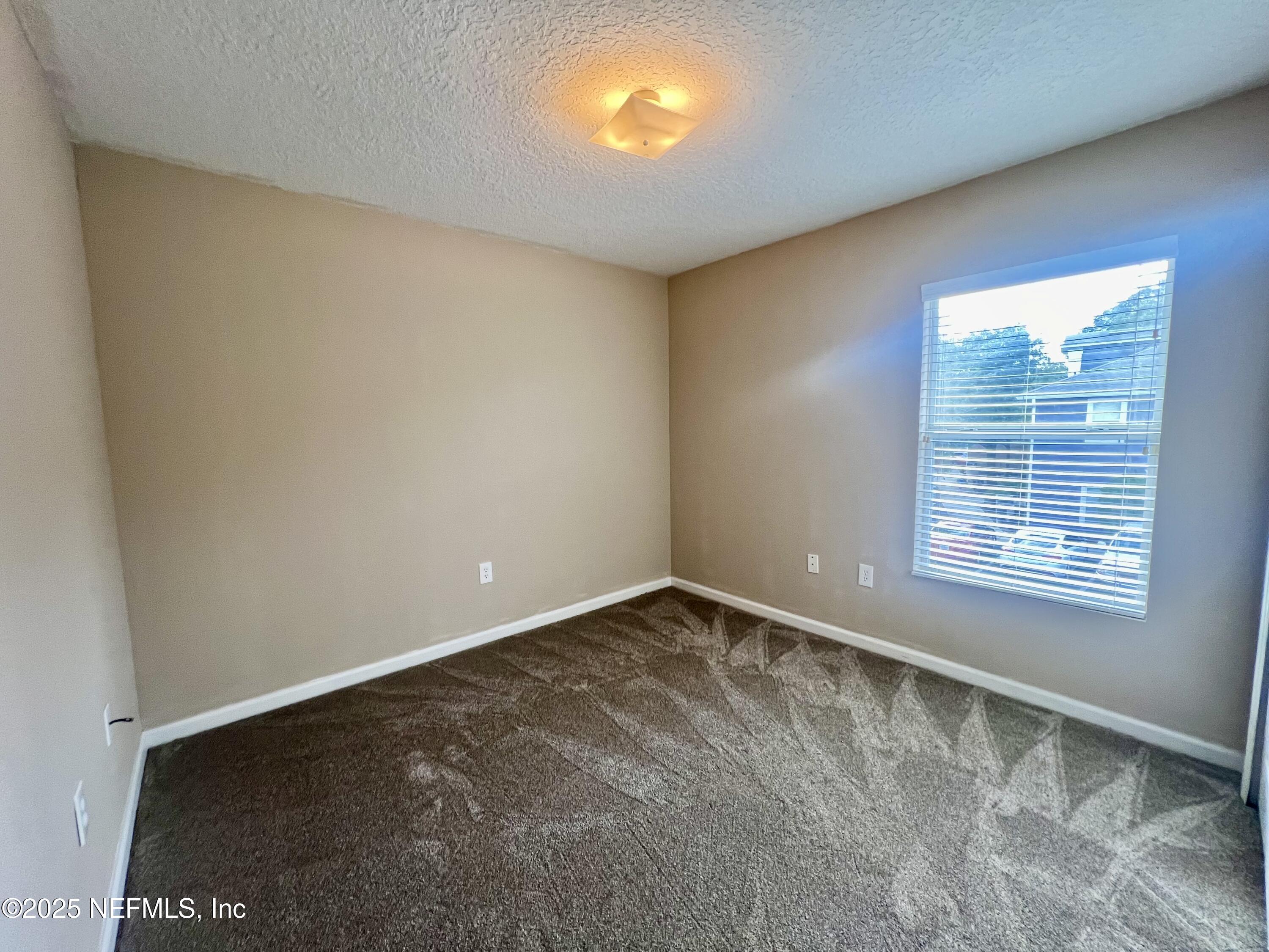7920 Merrill Road, Unit 709 Jacksonville, FL 32277 - Photo 18 of 35 a view of an empty room with a window
