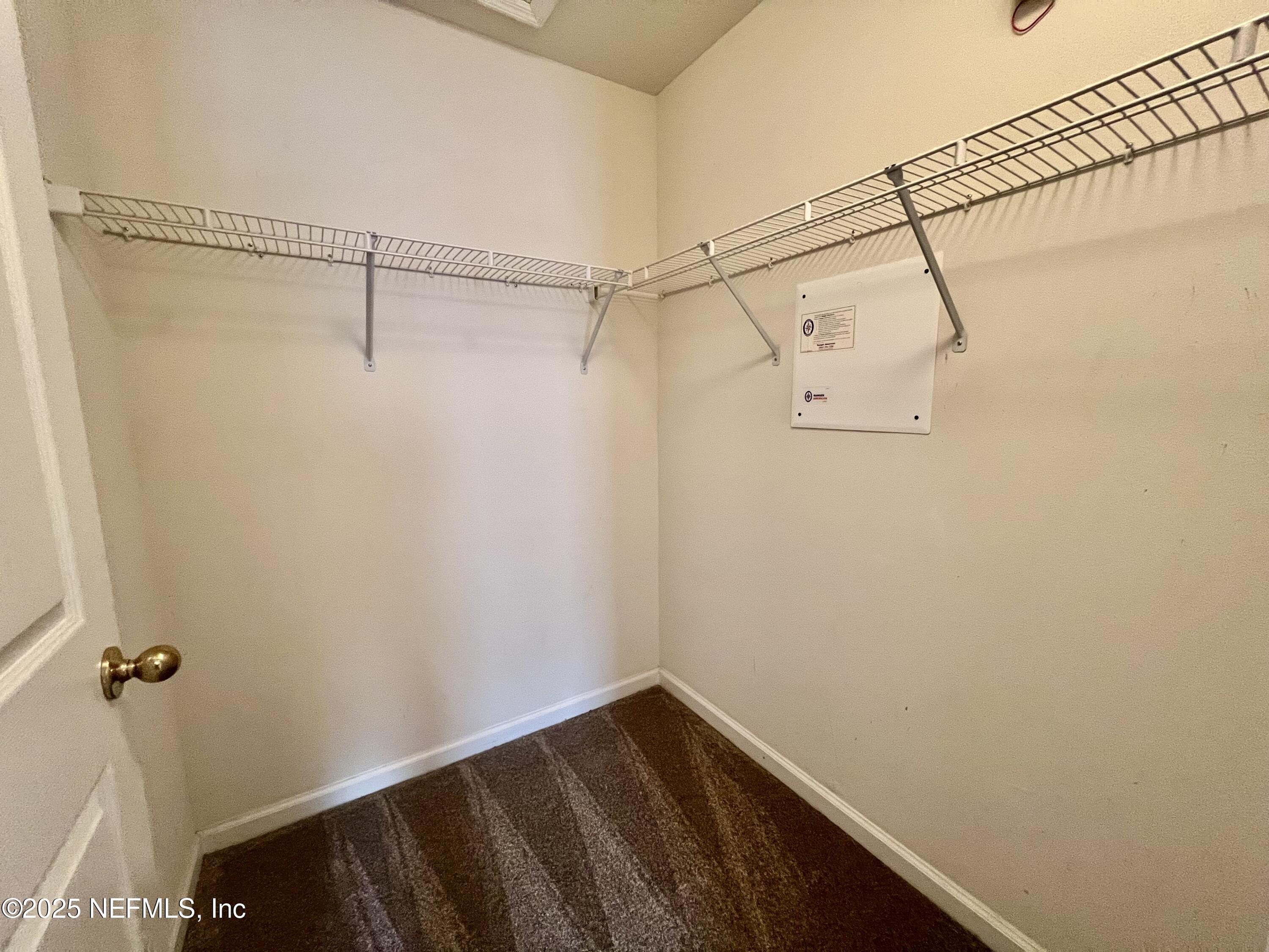 7920 Merrill Road, Unit 709 Jacksonville, FL 32277 - Photo 22 of 35 a view of a room with racks on the wall