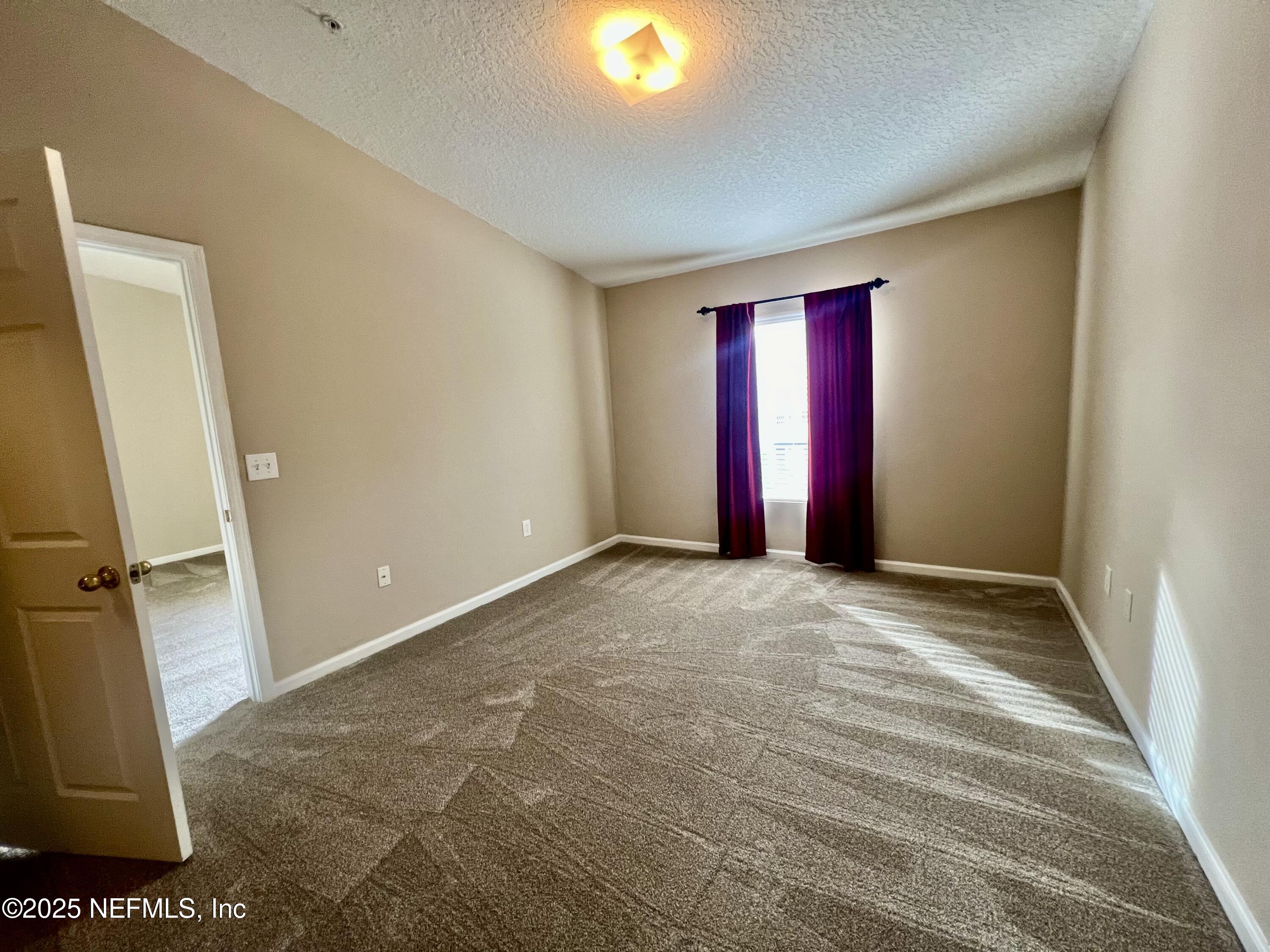 7920 Merrill Road, Unit 709 Jacksonville, FL 32277 - Photo 26 of 35 a view of an empty room with a window