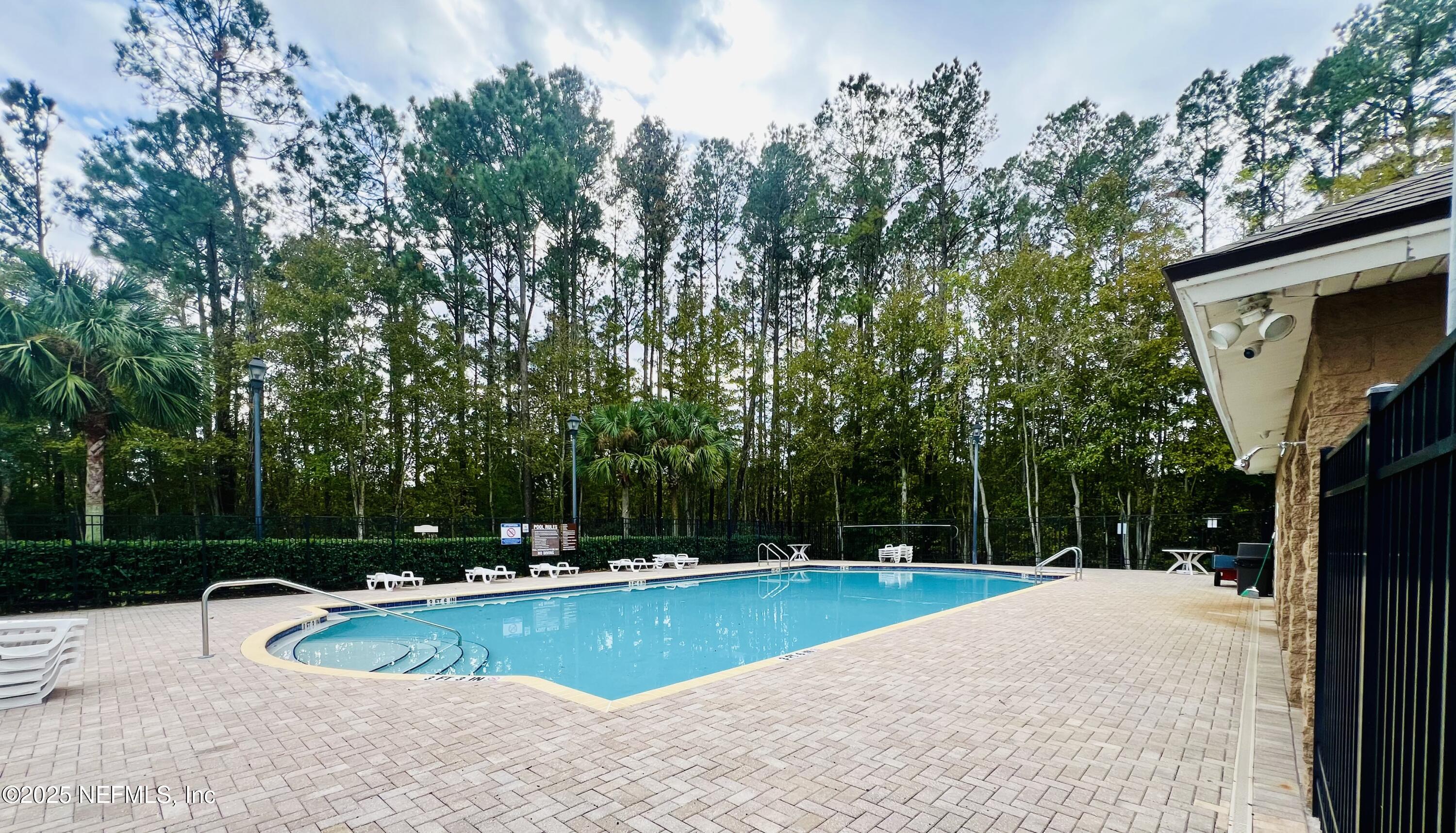 7920 Merrill Road, Unit 709 Jacksonville, FL 32277 - Photo 34 of 35 a view of a swimming pool with a patio