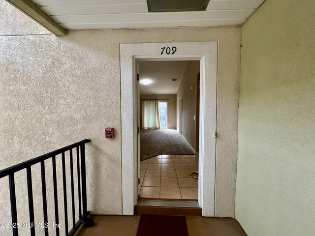 a kitchen with a refrigerator and a sink