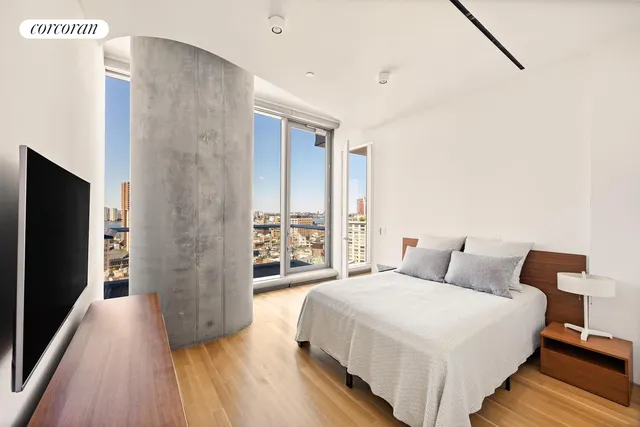 a bedroom with a bed and a large mirror