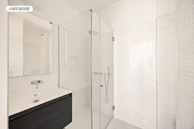 a bathroom with a shower and a sink