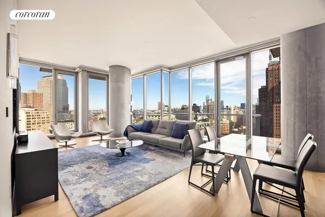a living room with furniture and large windows