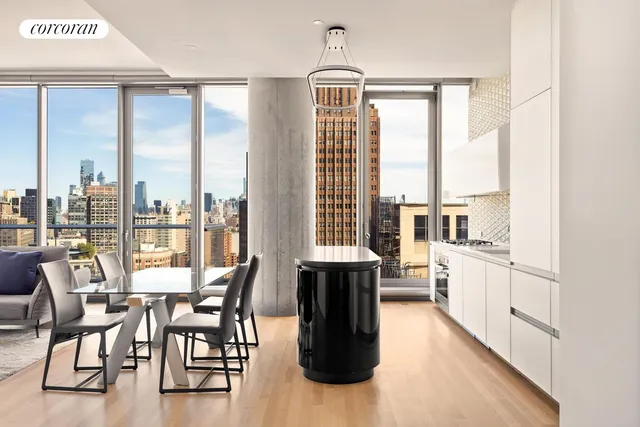 a dining table with chairs and view of kitchen