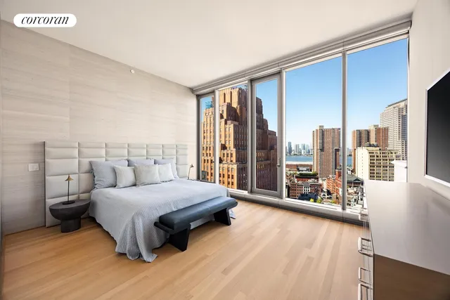 a bedroom with a large bed and a large window