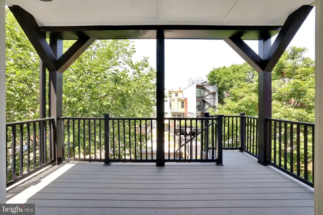 a view of a balcony with wooden floor and outdoor space