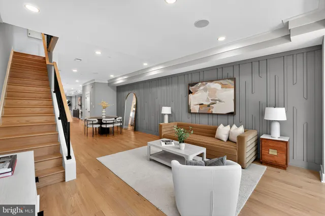 a living room with furniture and wooden floor