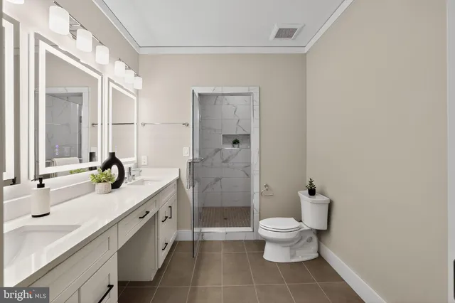 a bathroom with double vanity sinks and a mirror