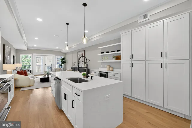 a kitchen with a sink a stove and cabinets