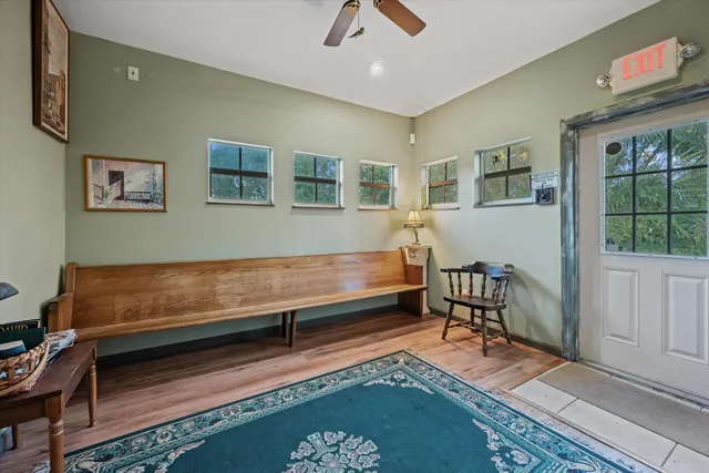 a living room with furniture and paintings on the wall