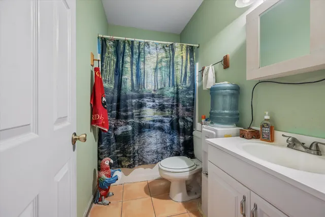 a living room with furniture a rug and a flat screen tv