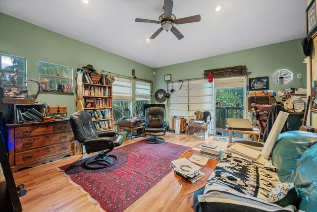 a view of a livingroom with workspace and a window