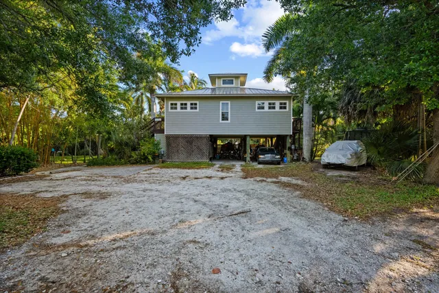 a view of a house with a yard and tree s