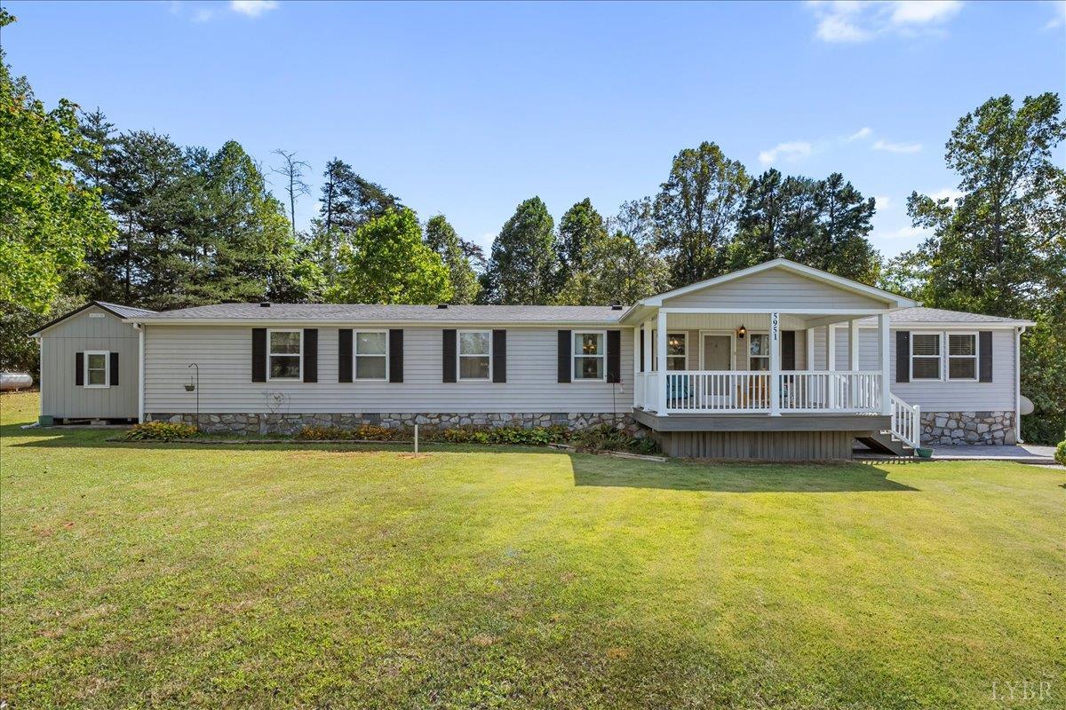 a front view of a house with swimming pool having outdoor seating